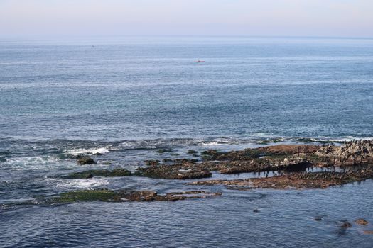 Peaceful coastal scene in La Jolla, San Diego with rocks and ocean waves.