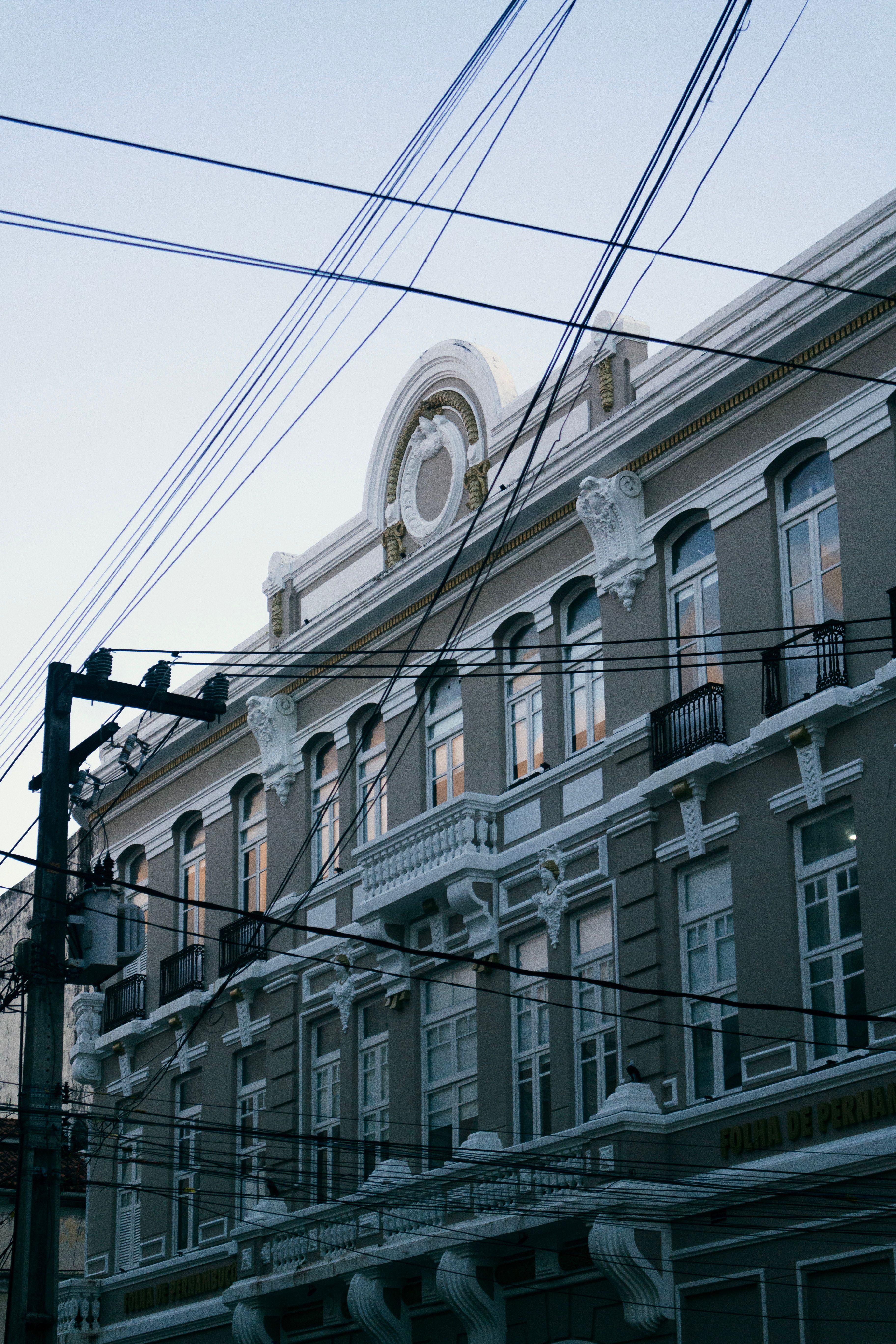 Historic Building with Overhead Power Lines at Dusk · Free Stock Photo