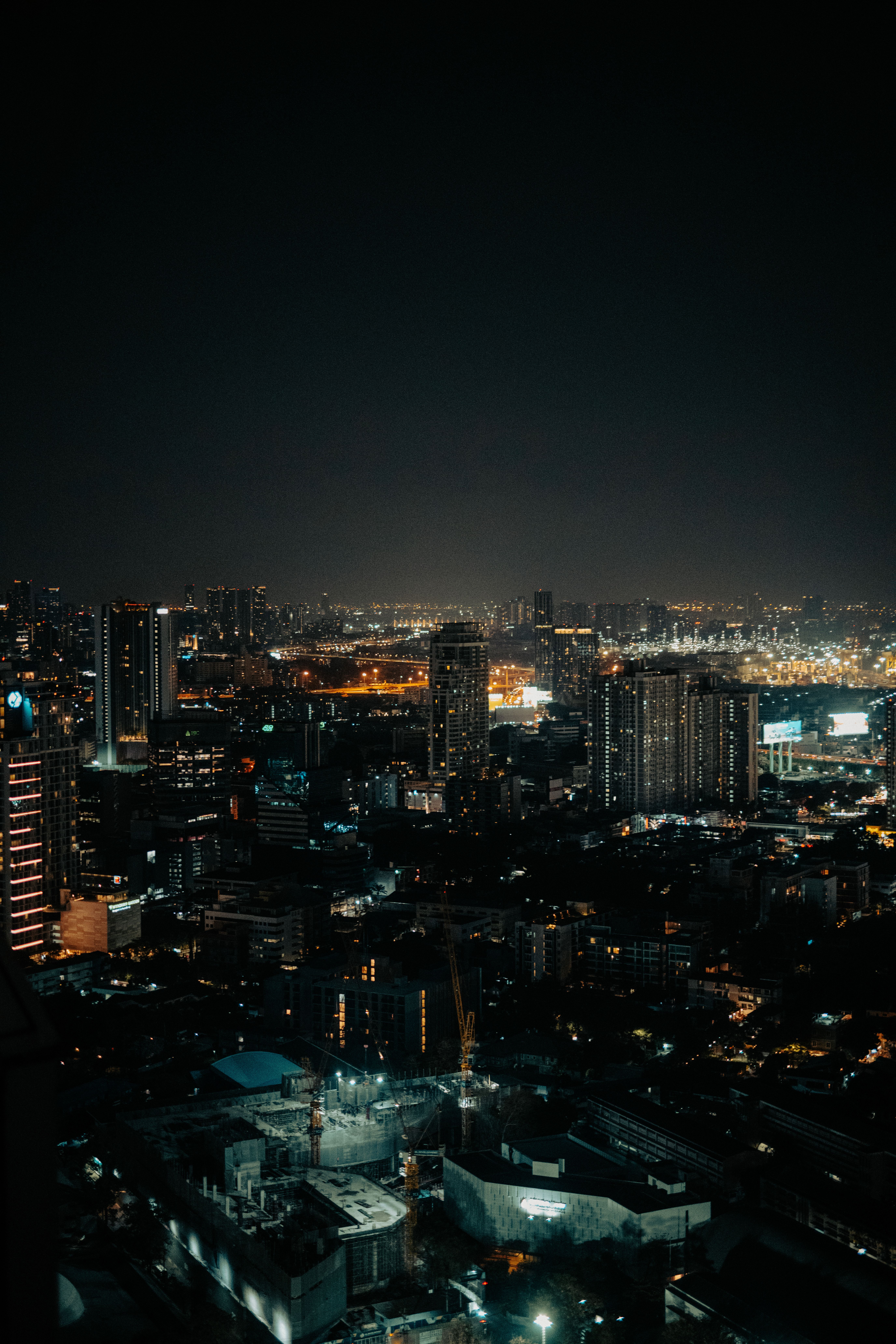 A breathtaking night view of an illuminated urban skyline, capturing the vibrant city life at night.