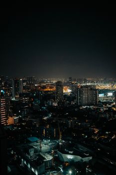 A breathtaking night view of an illuminated urban skyline, capturing the vibrant city life at night.