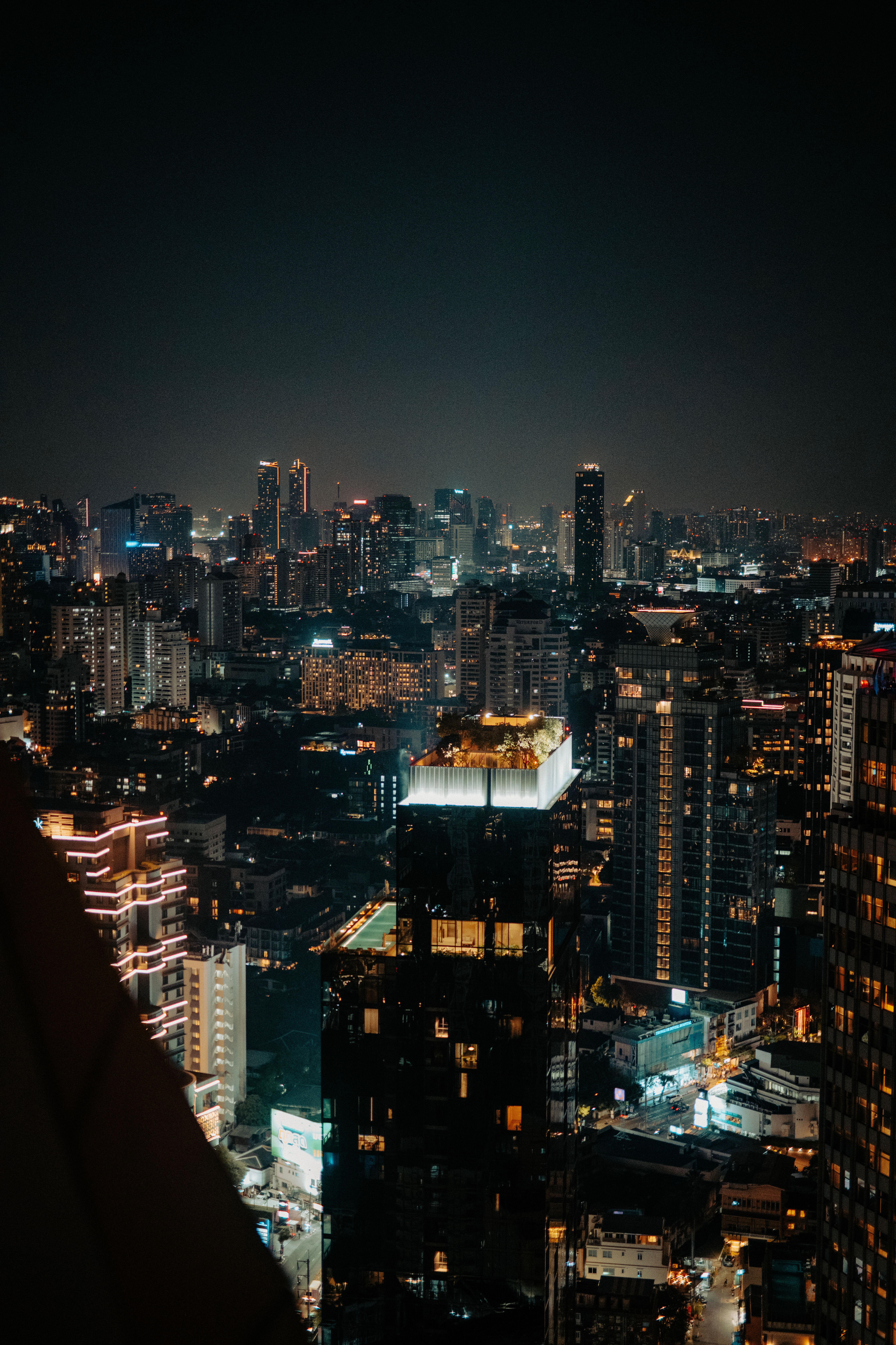 A stunning view of a modern city skyline illuminated at night with vibrant lights.