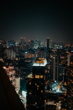 A stunning view of a modern city skyline illuminated at night with vibrant lights.