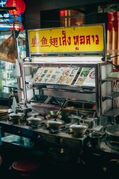 Authentic Asian street food stall at night, showcasing diverse culinary offerings.