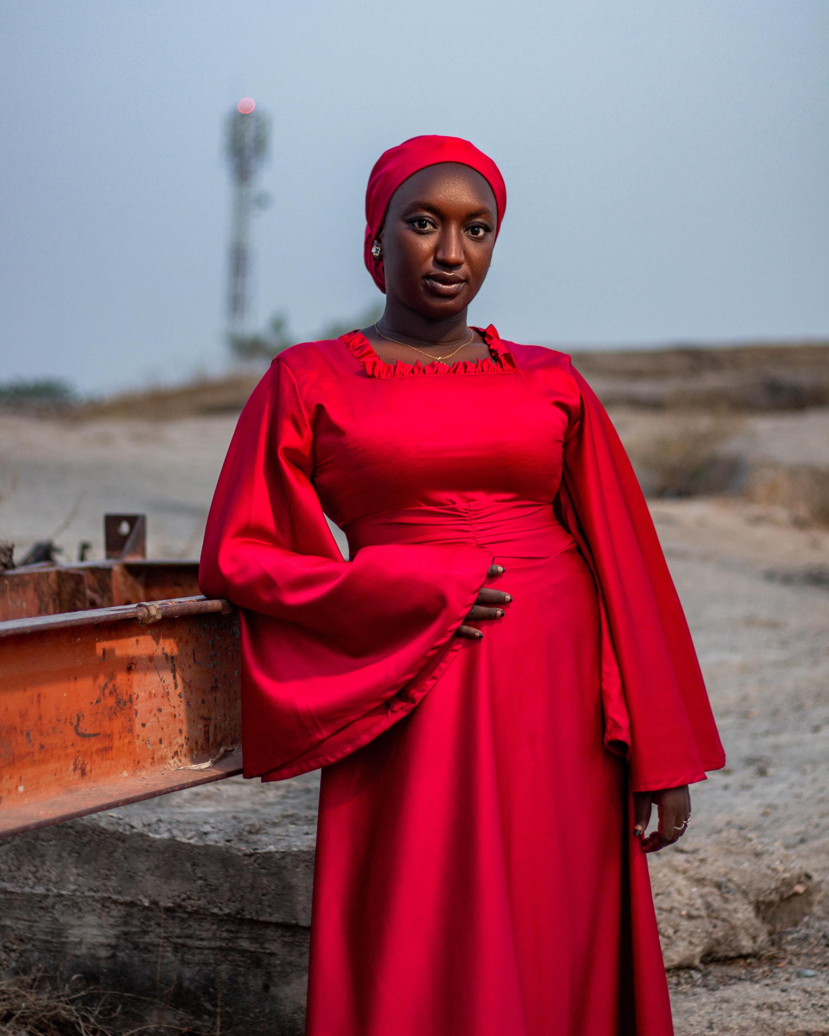 Elegant Woman in Red Dress Outdoors at Dusk · Free Stock Photo