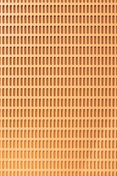 背景为抽象的橙色图案，带有无缝矩形孔，适用于设计