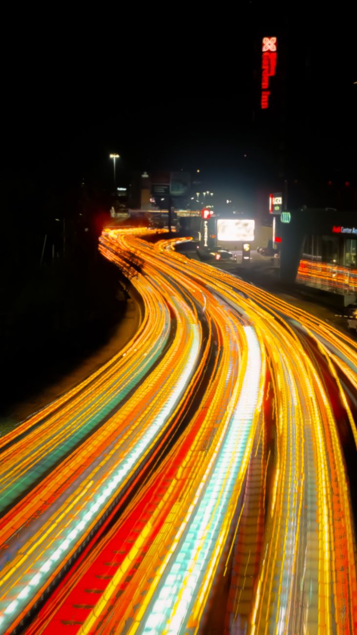 Vivid long exposure photo capturing colorful light trails on a busy city highway at night.. pexels, vivid, long