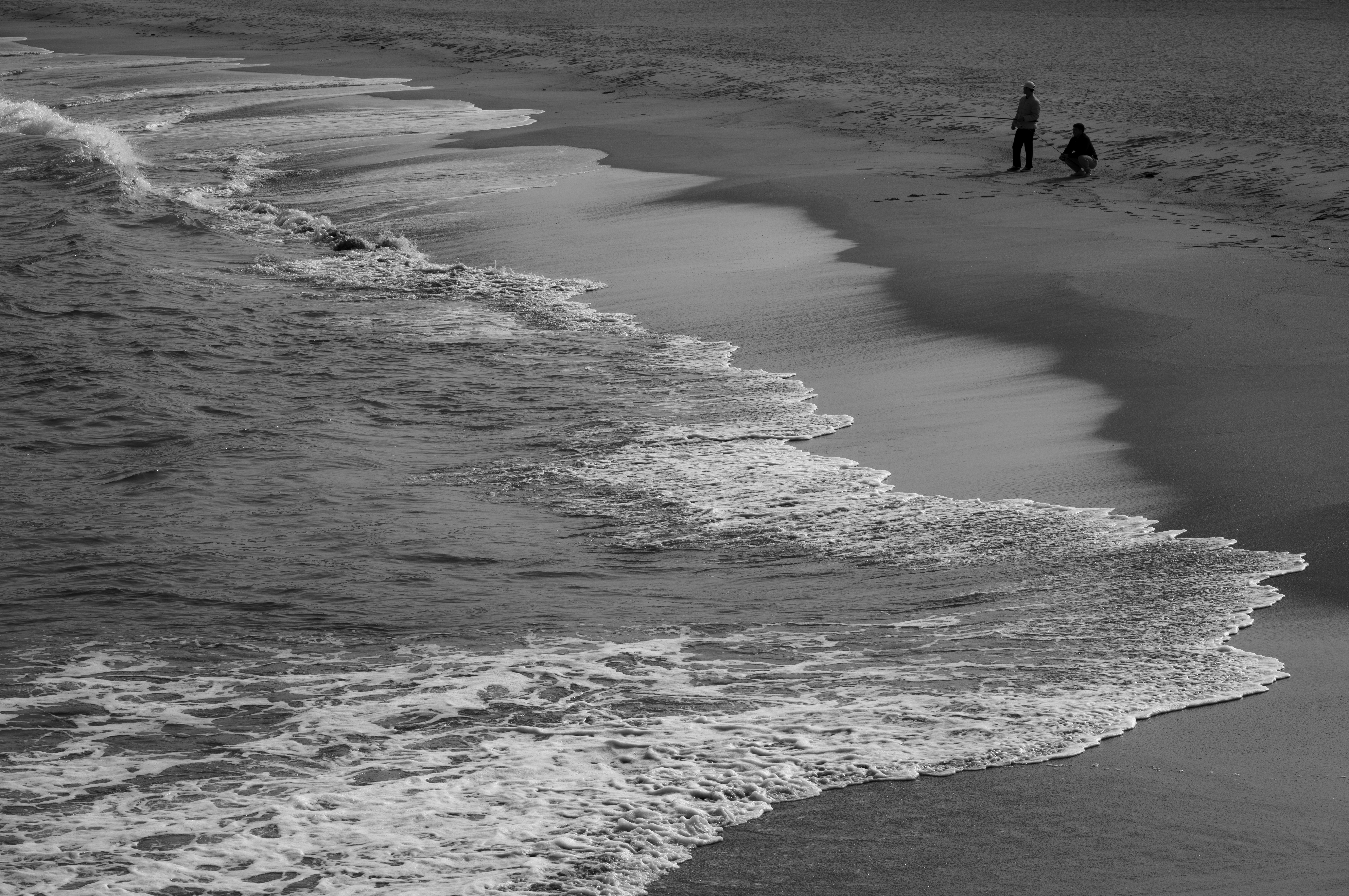Black and White Ocean Waves on Sandy Beach · Free Stock Photo