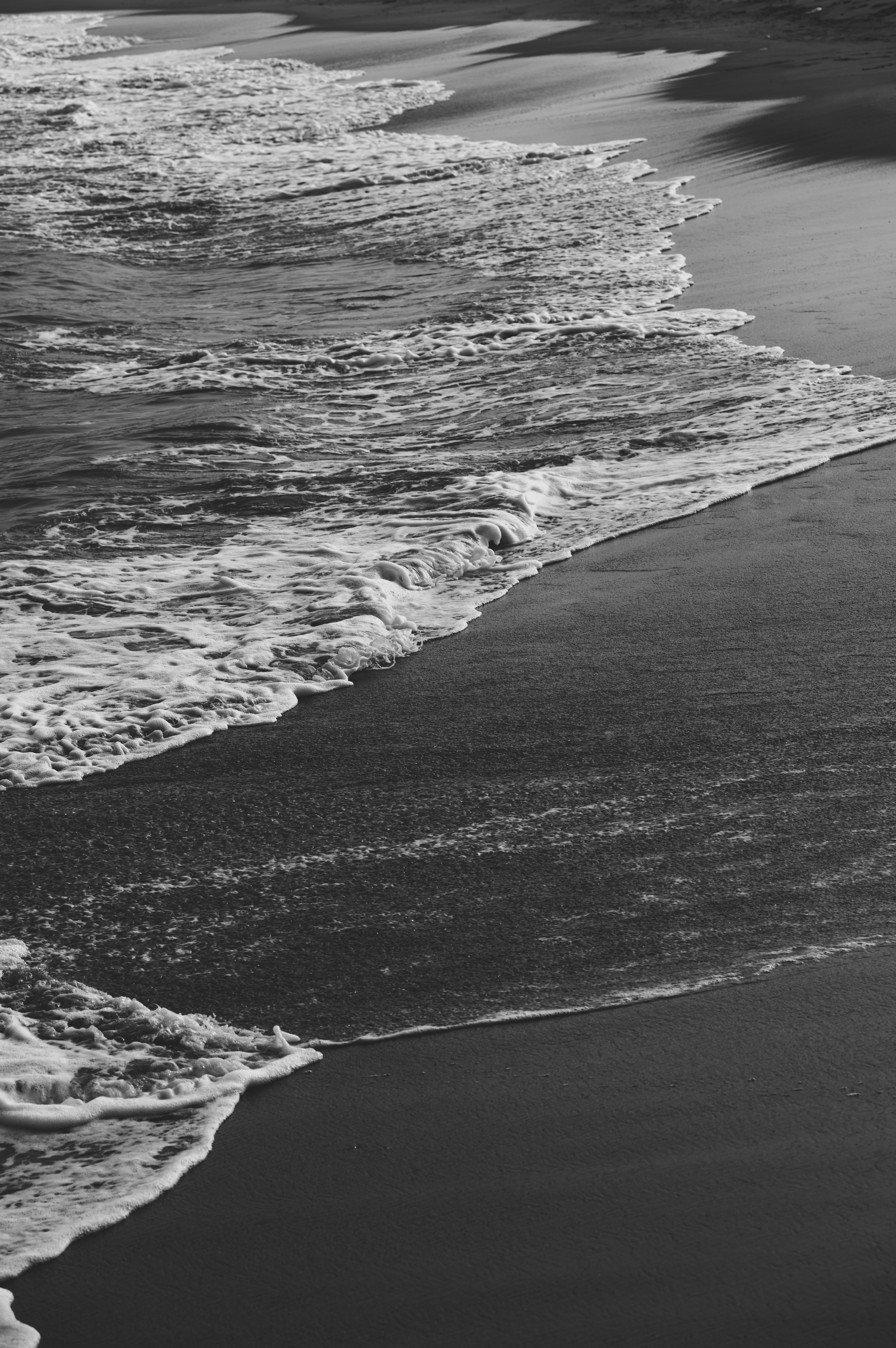 Black and White Ocean Waves on Sandy Beach · Free Stock Photo