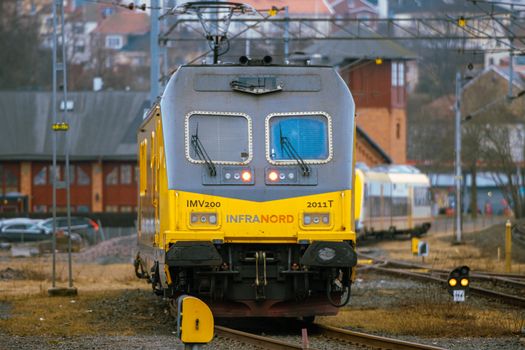 Front view of a yellow train at Jönköping railway station, Sweden, during day.