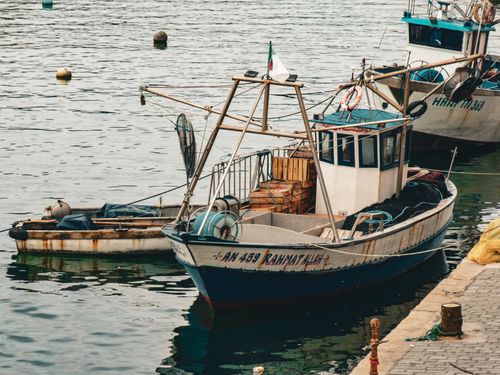 Free Fishing boats docked at a tranquil harbor, showcasing maritime activities and nautical charm. Stock Photo