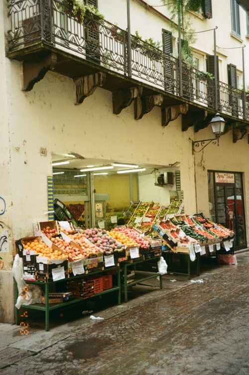 Free A quaint outdoor fruit market with fresh produce in an Italian street setting. Stock Photo