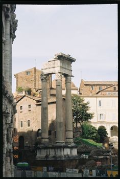Historical Roman architecture with Corinthian columns and worn stone structures.