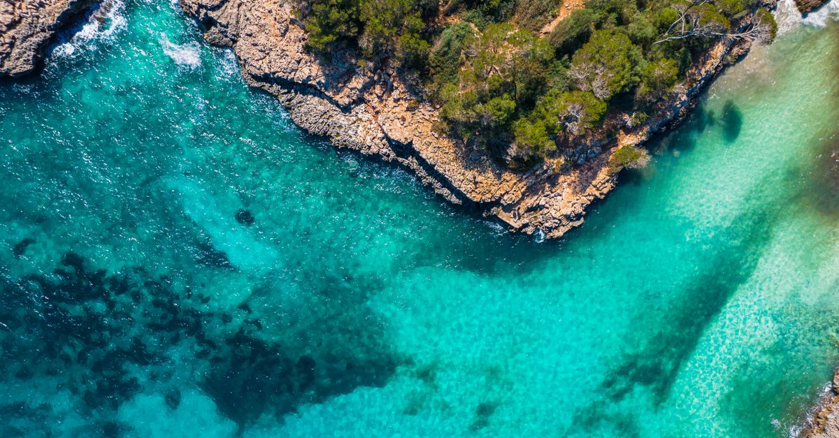 Turquoise water and sandy cove in the Balearic Islands