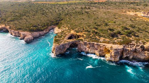 Free Breathtaking aerial view of Mallorca's rugged coastline with striking cliffs and vibrant blue sea. Stock Photo