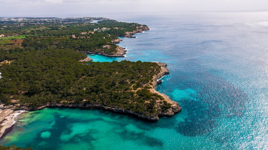 Turquoise water against a rugged rocky coastline — photo by Mike Art on Pexels