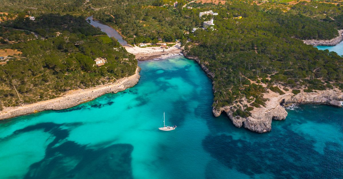 Turquoise cove in the Balearic Islands with limestone cliffs