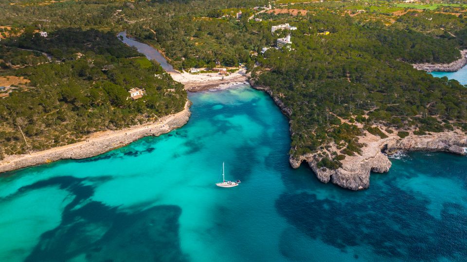 Turquoise cove in the Balearic Islands with limestone cliffs