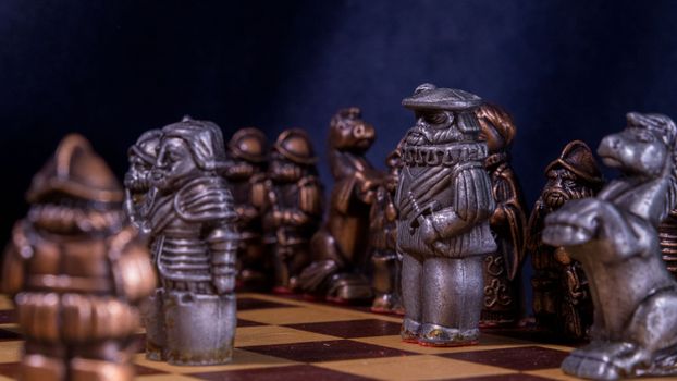 Close-up of a medieval themed chess set on a detailed wooden board, Madrid, Spain.