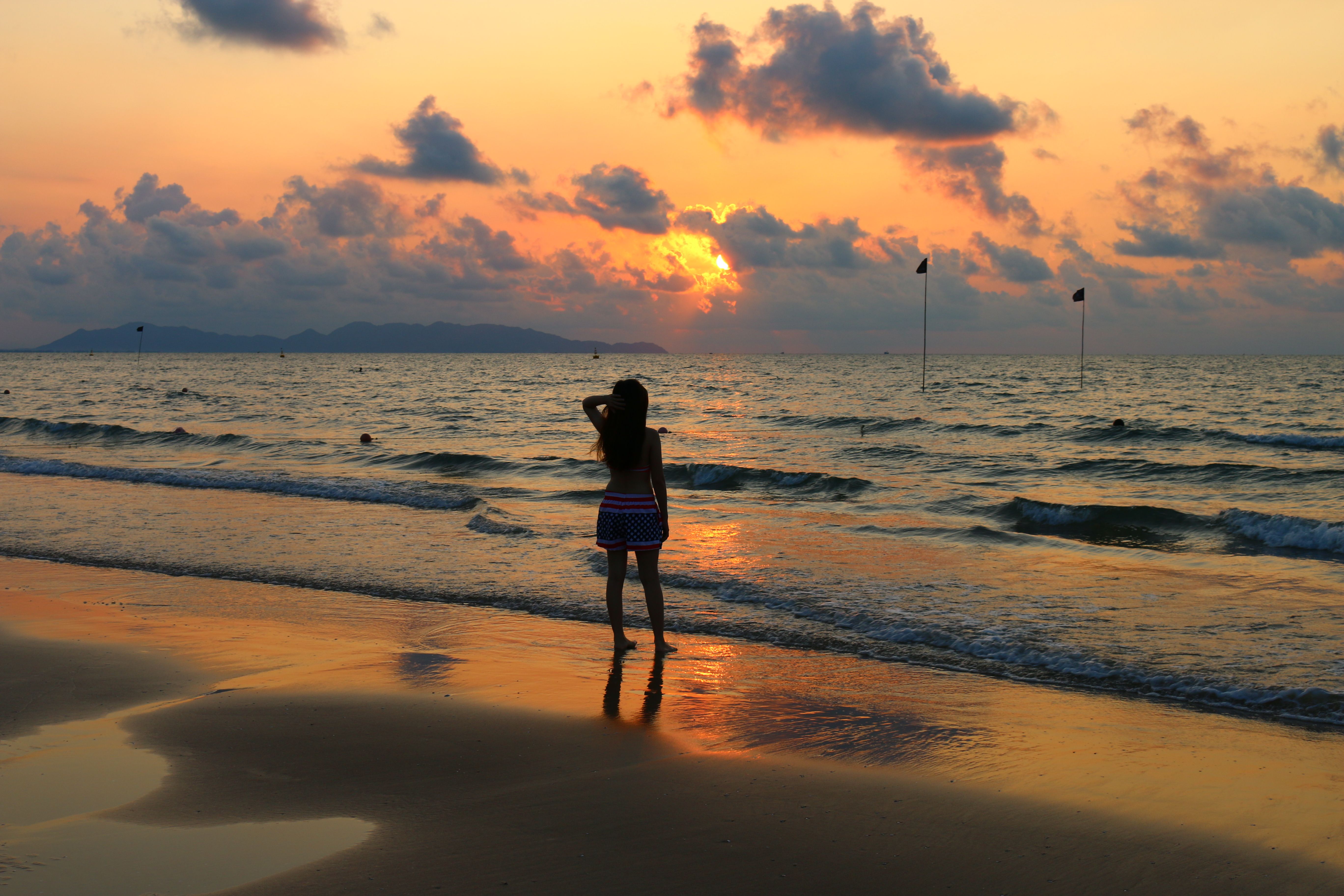 Girl in Hat and Bright Top Walking on the Beach · Free Stock Photo