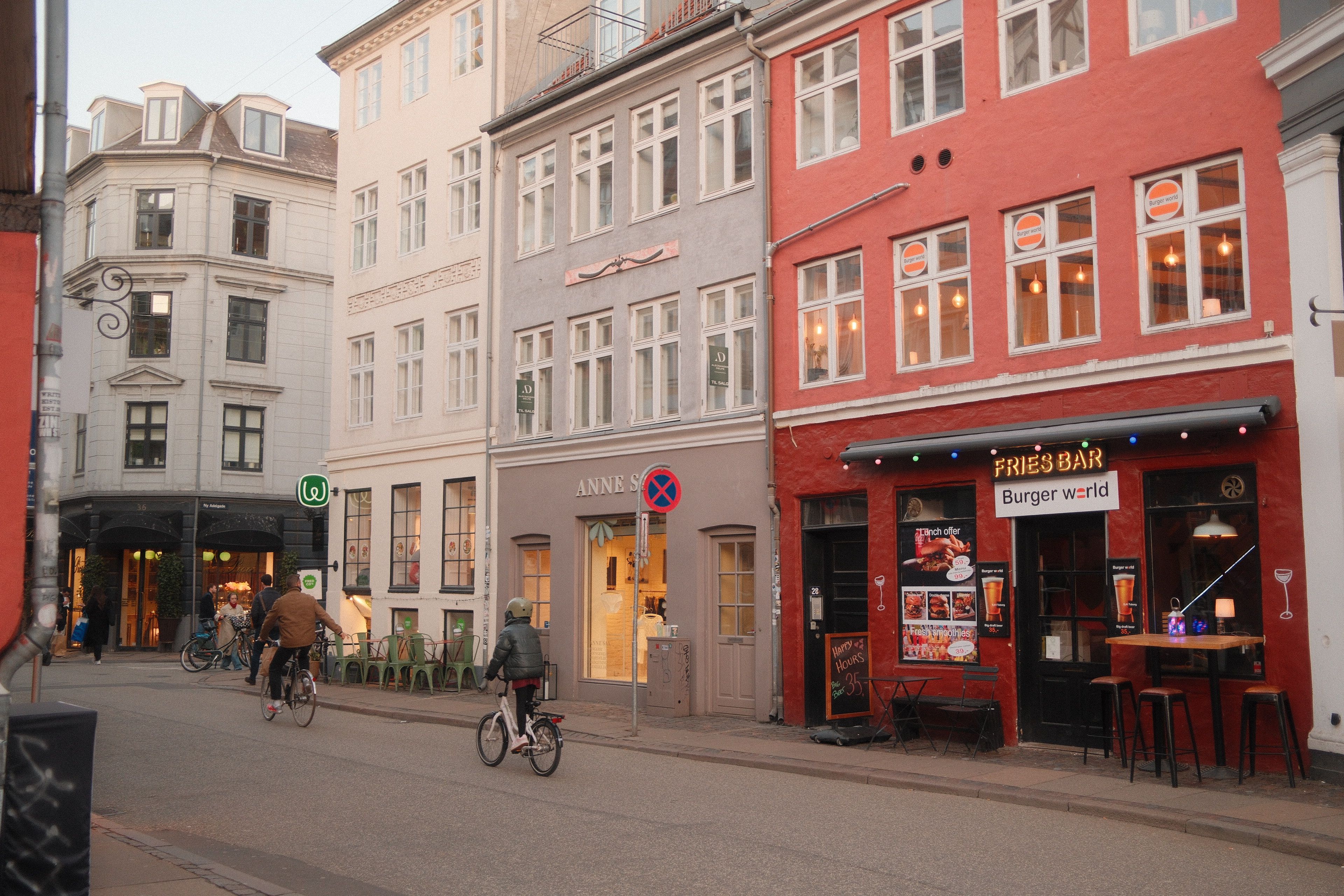Charming Copenhagen cityscape featuring colorful facades and bicycles on a peaceful street.