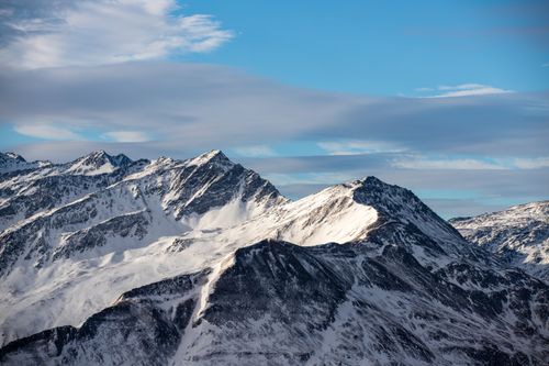 Free Breathtaking view of snow-covered peaks in Carinthian Alps under a vibrant blue sky. Stock Photo