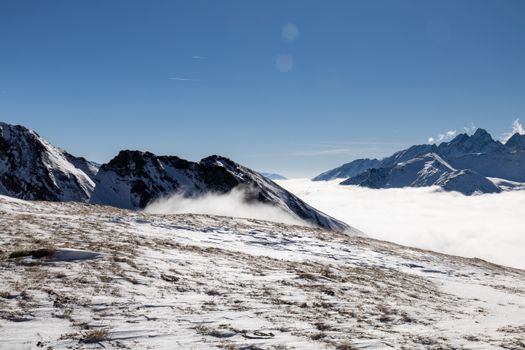 Dramatic view of snow-capped mountains and clouds in Heiligenblut, Austria.