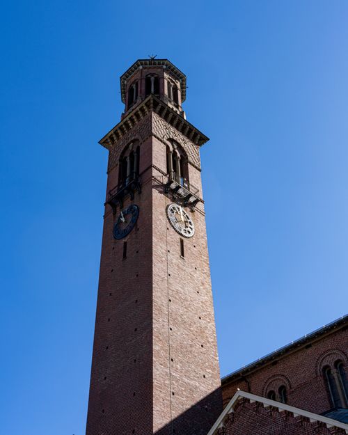 Free A towering clock tower at Harvard Square, Cambridge, MA, set against a vivid blue sky. Stock Photo