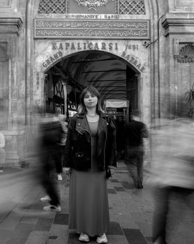 Stylish black and white portrait of a woman at the historic Grand Bazaar, Istanbul.