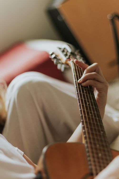 Free Close-up of person playing acoustic guitar, creating a cozy and relaxed vibe. Stock Photo