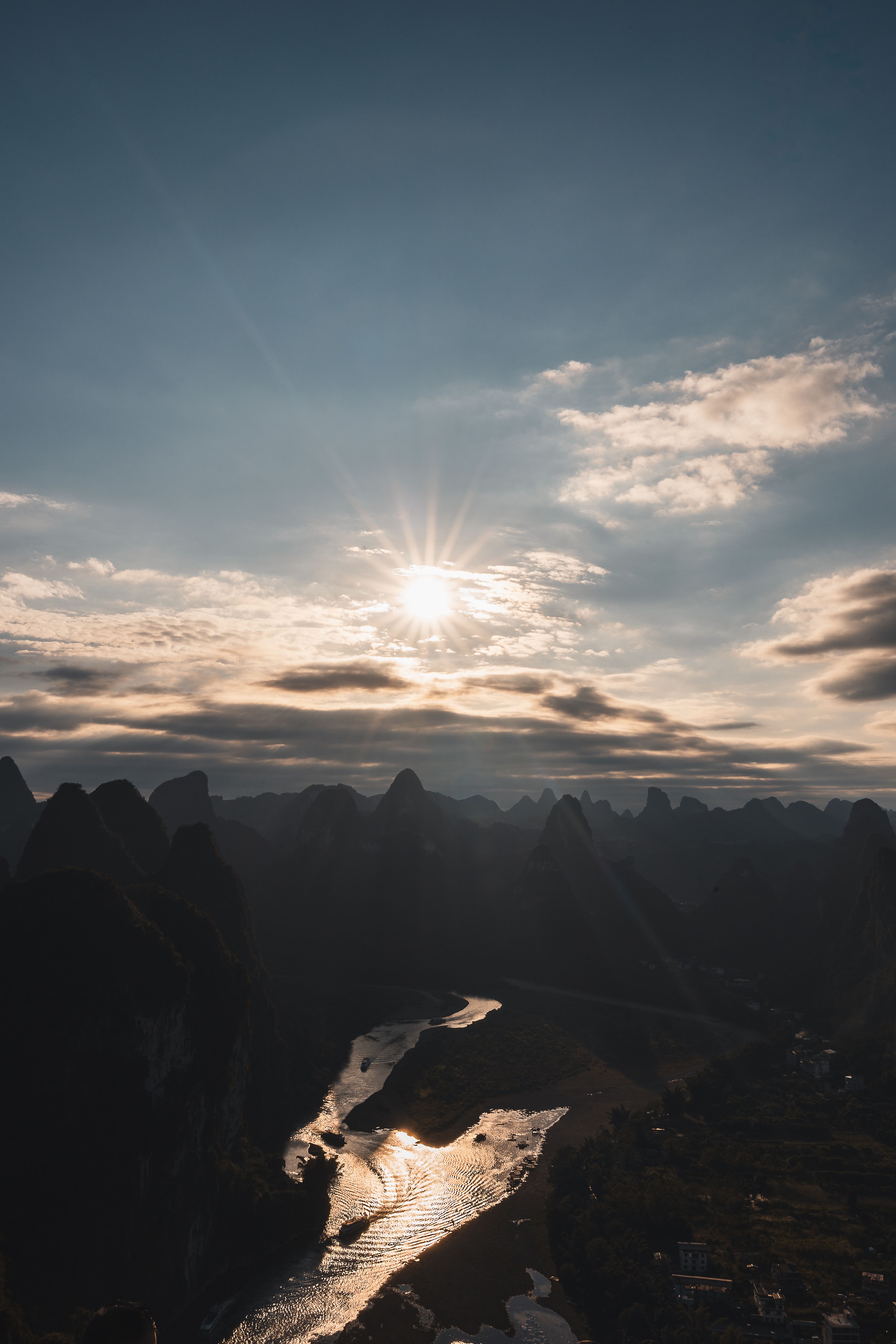 Stunning view of the Li River winding through karst mountains at sunset in Guilin, China.