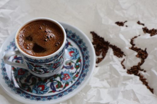 Free Close-up of Turkish coffee in an ornate cup on crumpled paper background. Stock Photo