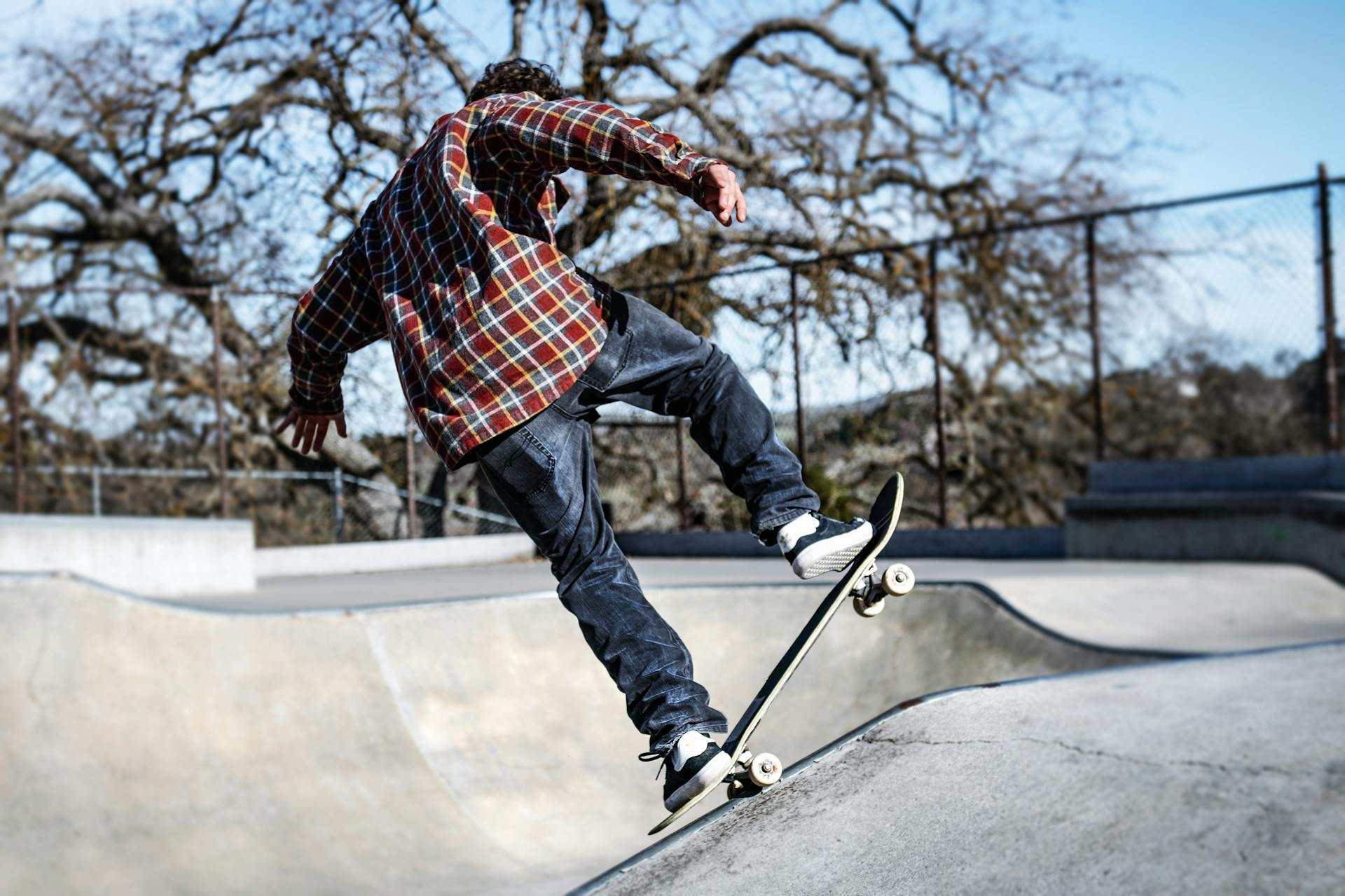 A skater executes a trick at a skate park in Templeton, CA, showcasing dynamic action and youthful energy.