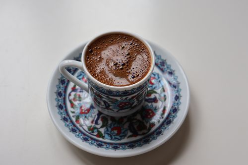 Free High-angle view of Turkish coffee served in a decorative, floral-patterned cup and saucer. Stock Photo