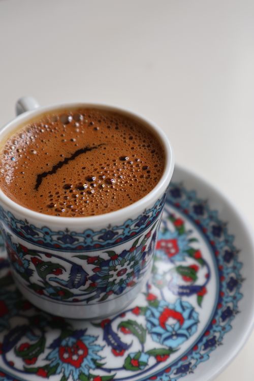 Free Close-up of Turkish coffee served in a decorative cup and saucer, rich with foam. Stock Photo