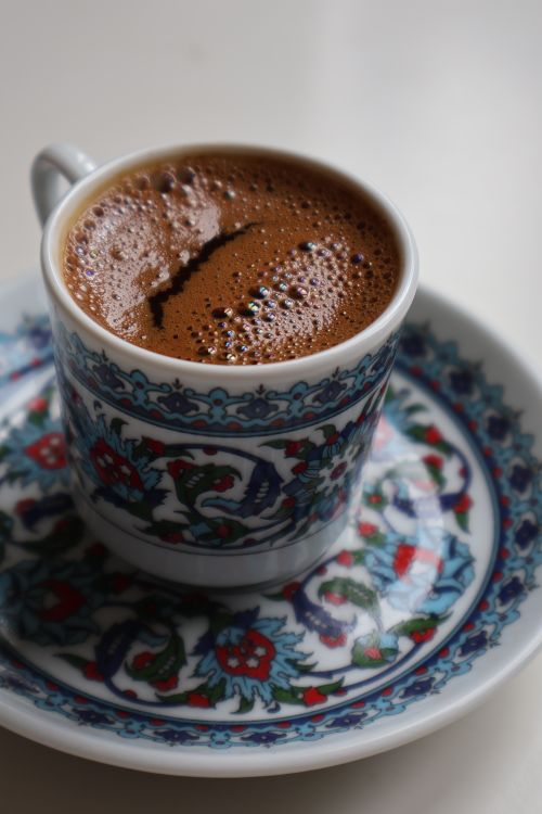 Free A beautifully detailed photo of Turkish coffee in a traditional ornate cup and saucer. Stock Photo
