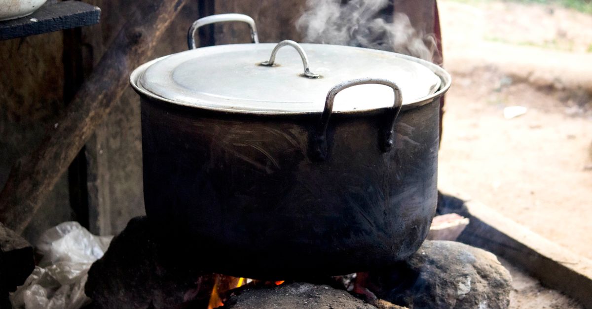 Vegetable scraps simmering in a large pot for homemade stock