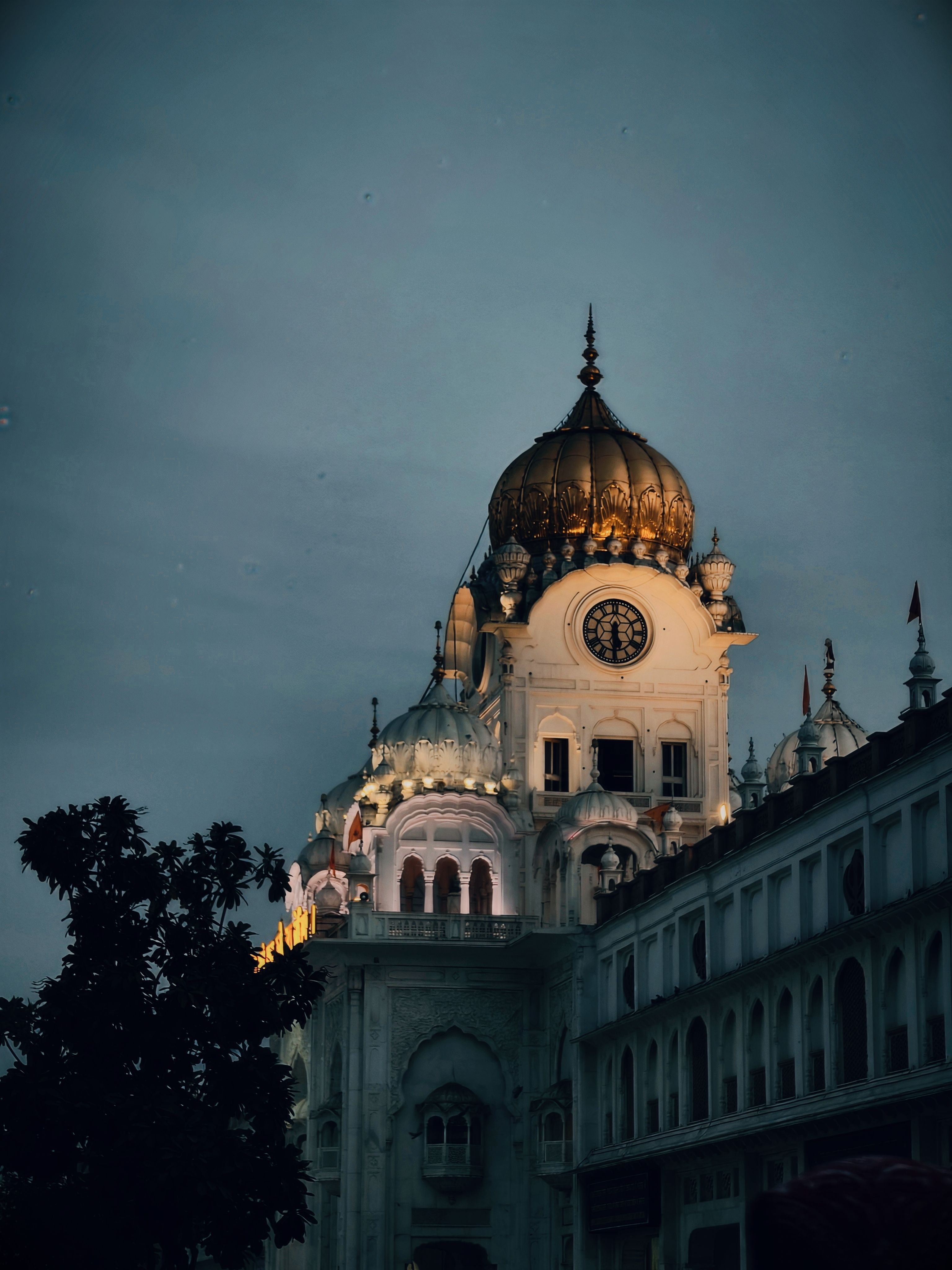 Majestic view of the illuminated Clock Tower of the Golden Temple in twilight, Amritsar, India