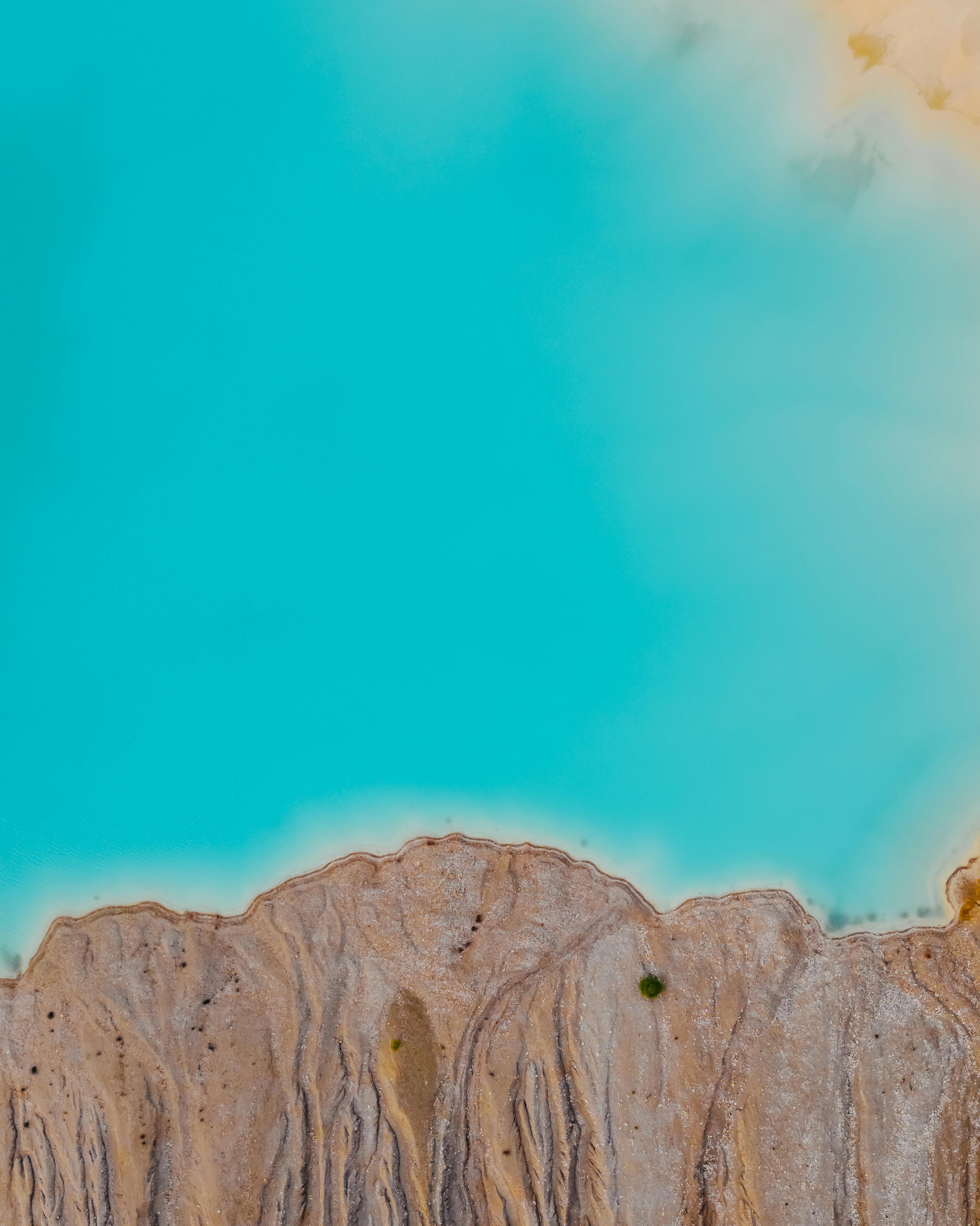 Free Stunning aerial shot of turquoise thermal pools against rocky landscape in Greece. Stock Photo