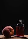 Moody Still Life with Apple and Bottle on Wooden Surface