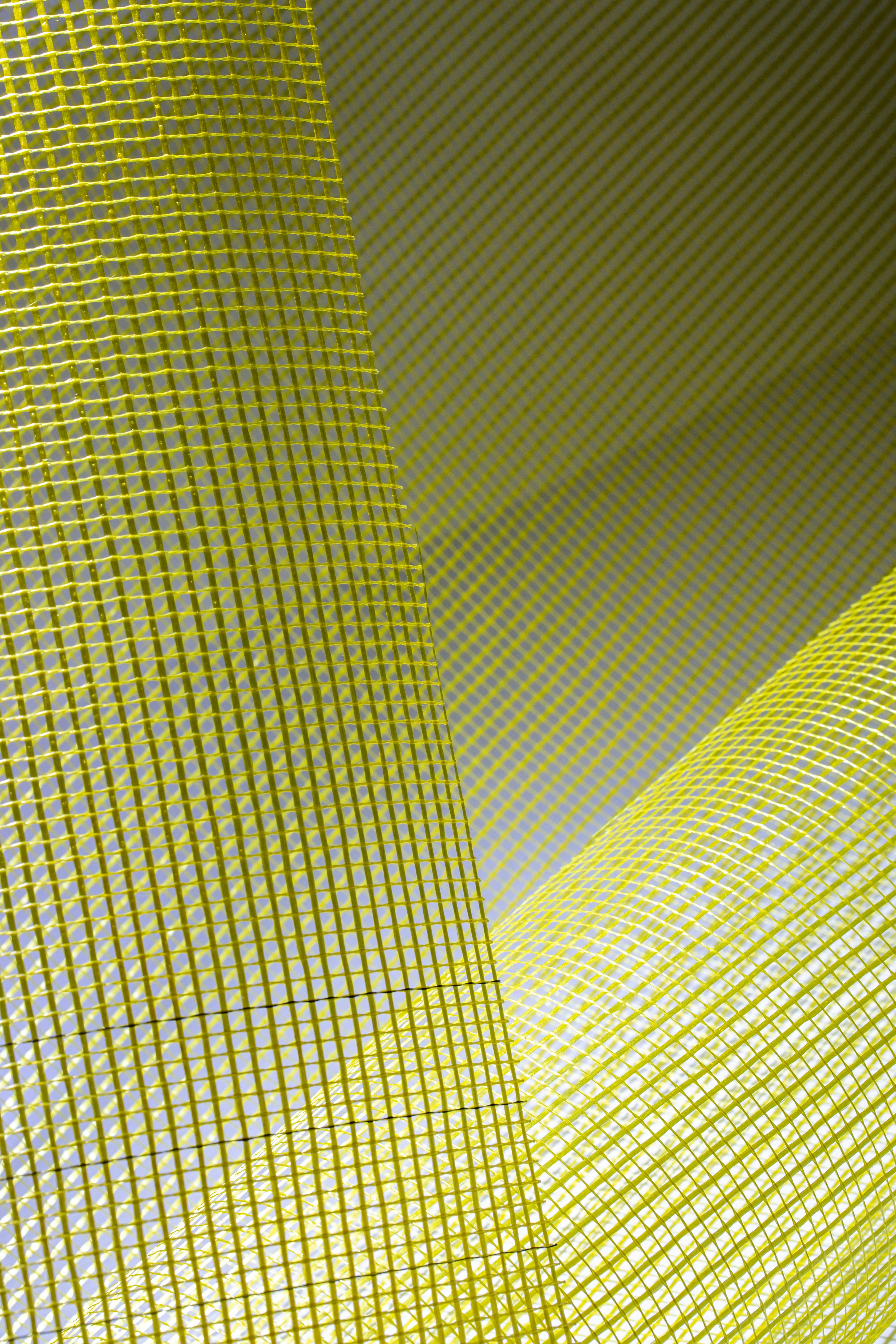 Free Artistic abstract image featuring a yellow mesh pattern with dynamic light and shadow play, perfect for modern themes. Stock Photo