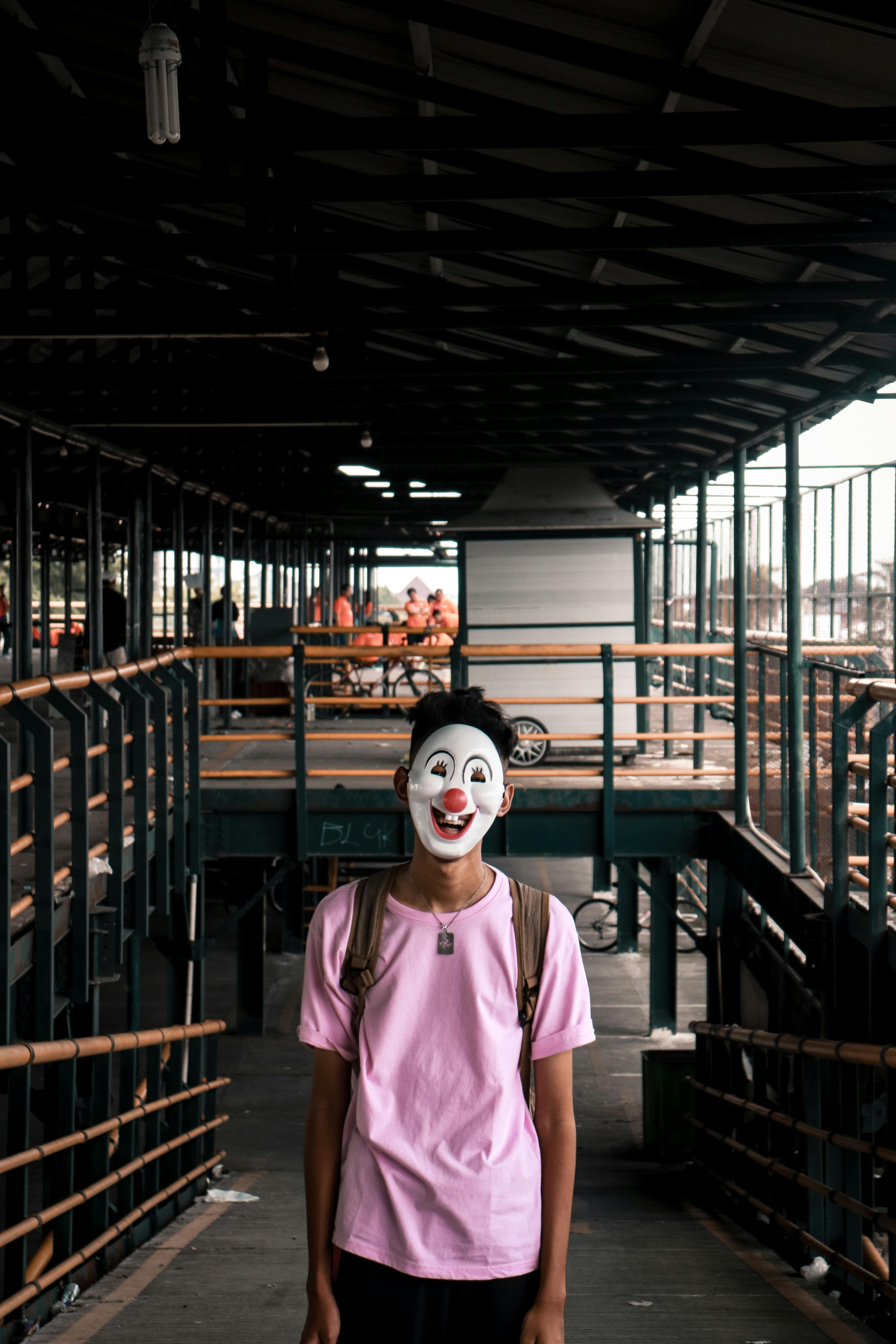 person wearing pink shirt and face mask