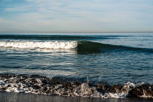 Free Tranquil view of ocean waves gently crashing on a sandy beach at a Georgian coastline. Stock Photo