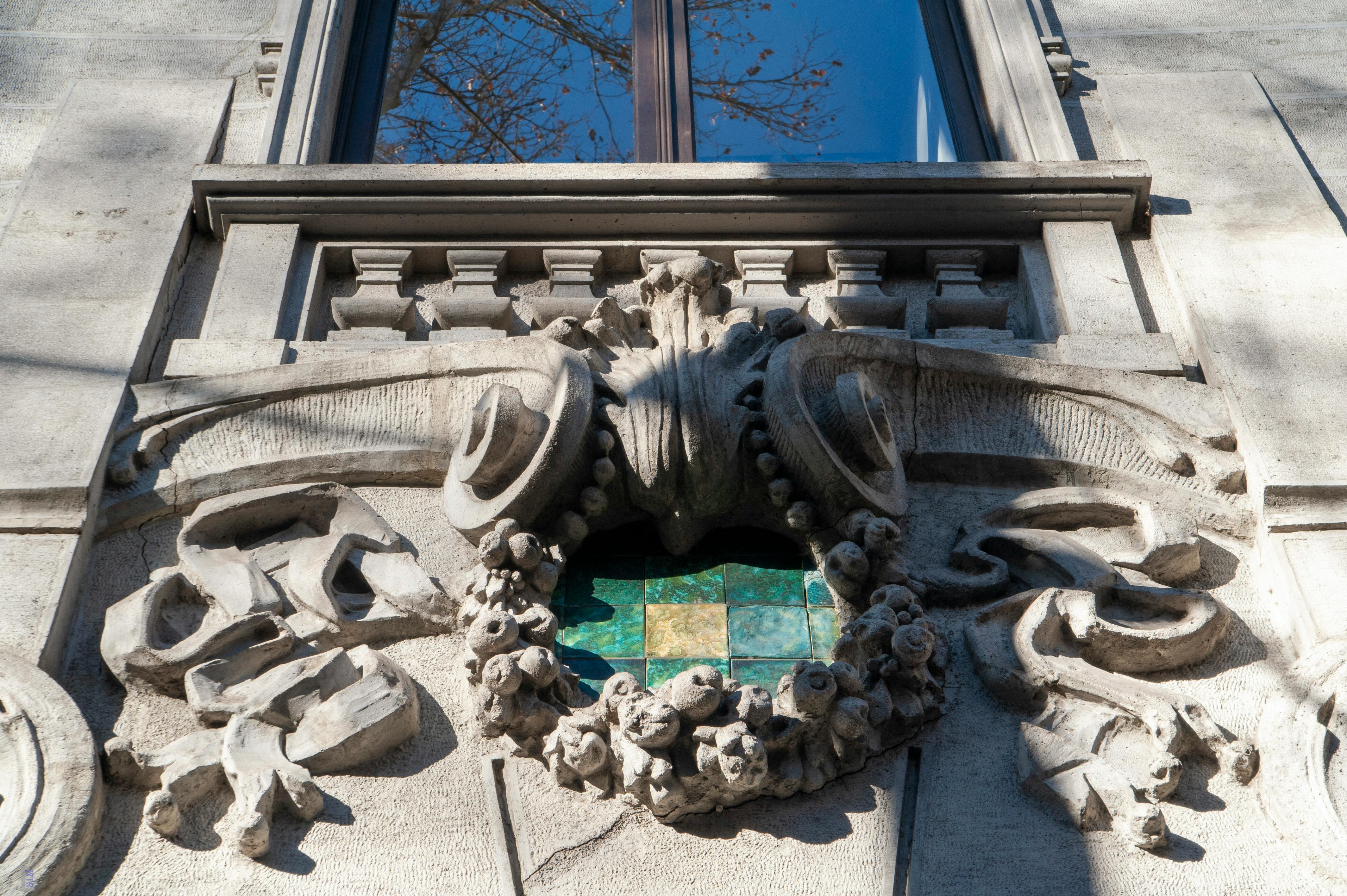 Free Close-up of an Art Nouveau facade in Tbilisi, showcasing intricate stone carvings and a decorative window. Stock Photo