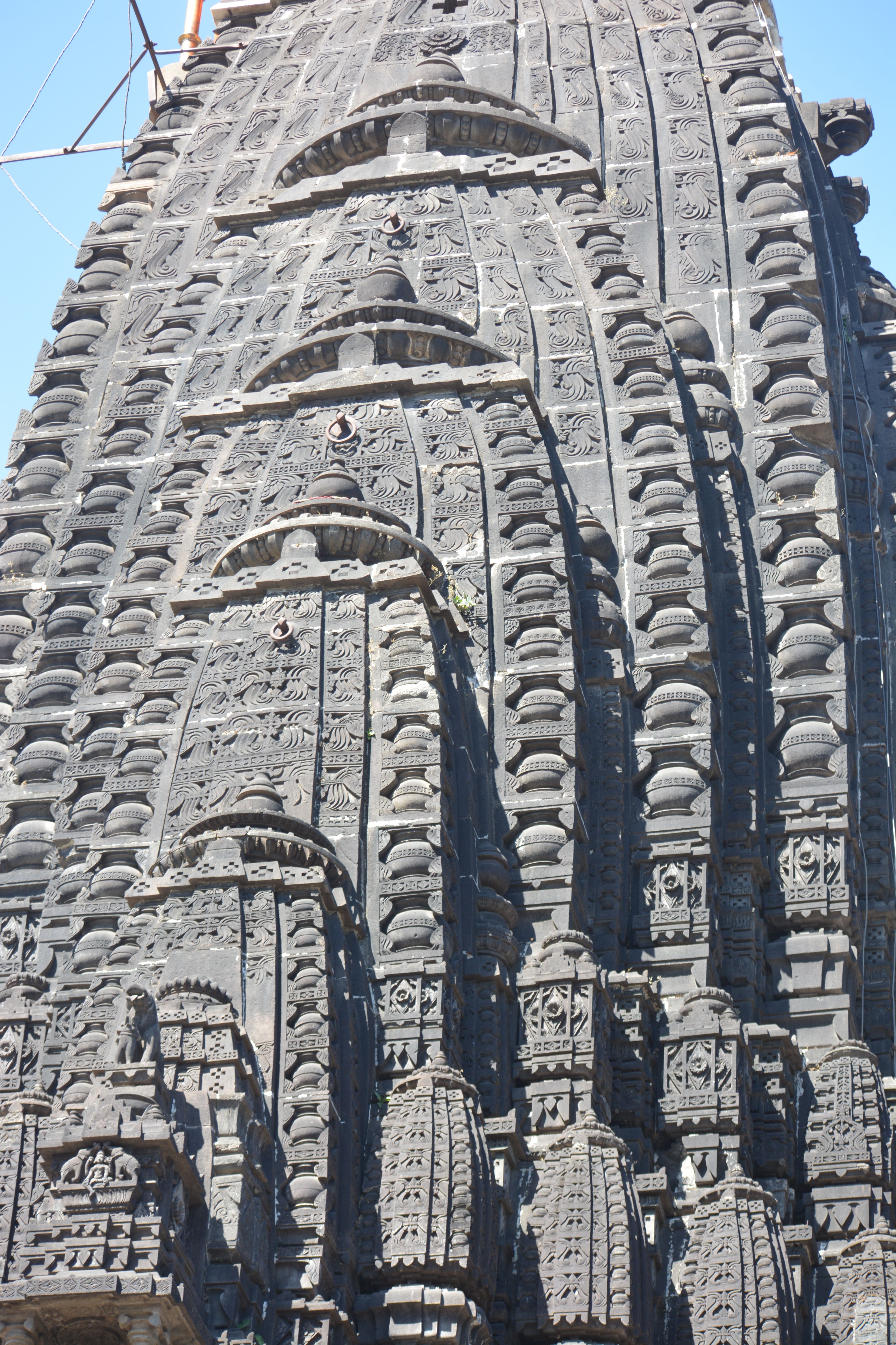 Close-up of detailed stone carvings on an ancient temple facade showcasing historical architecture.