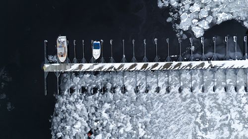 Free Aerial view of a snowy dock with boats in Jönköping, Sweden, highlighting winter's icy beauty. Stock Photo