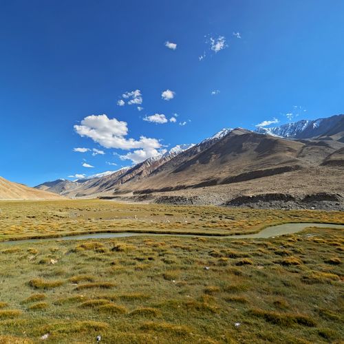 Free Breathtaking landscape of grassy plains and mountains under a clear blue sky in Leh, India. Stock Photo