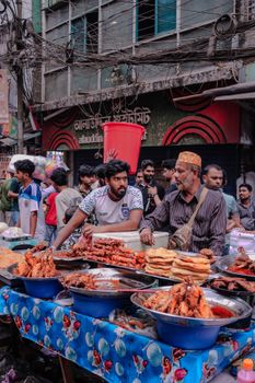 Lively street food market with diverse offerings and bustling crowd in an urban setting.