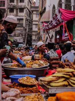 Lively street food scene capturing diverse dishes and bustling crowd in an urban market.