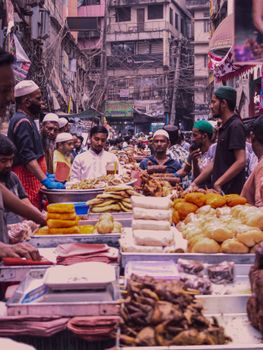 Colorful street food market bustling with life, offering diverse local cuisine in an urban setting.
