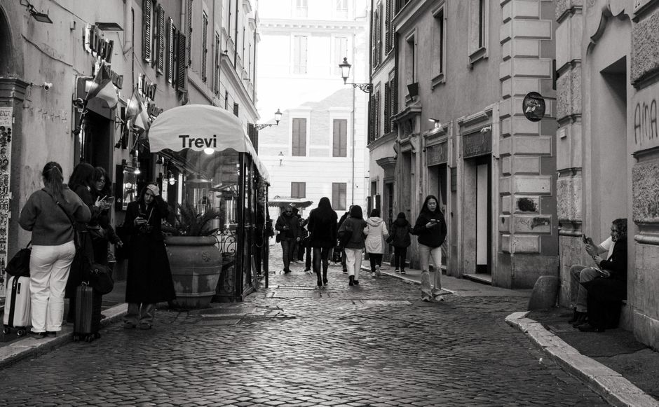Food tour participants enjoying local delicacies on a charming street in Trastevere, Rome